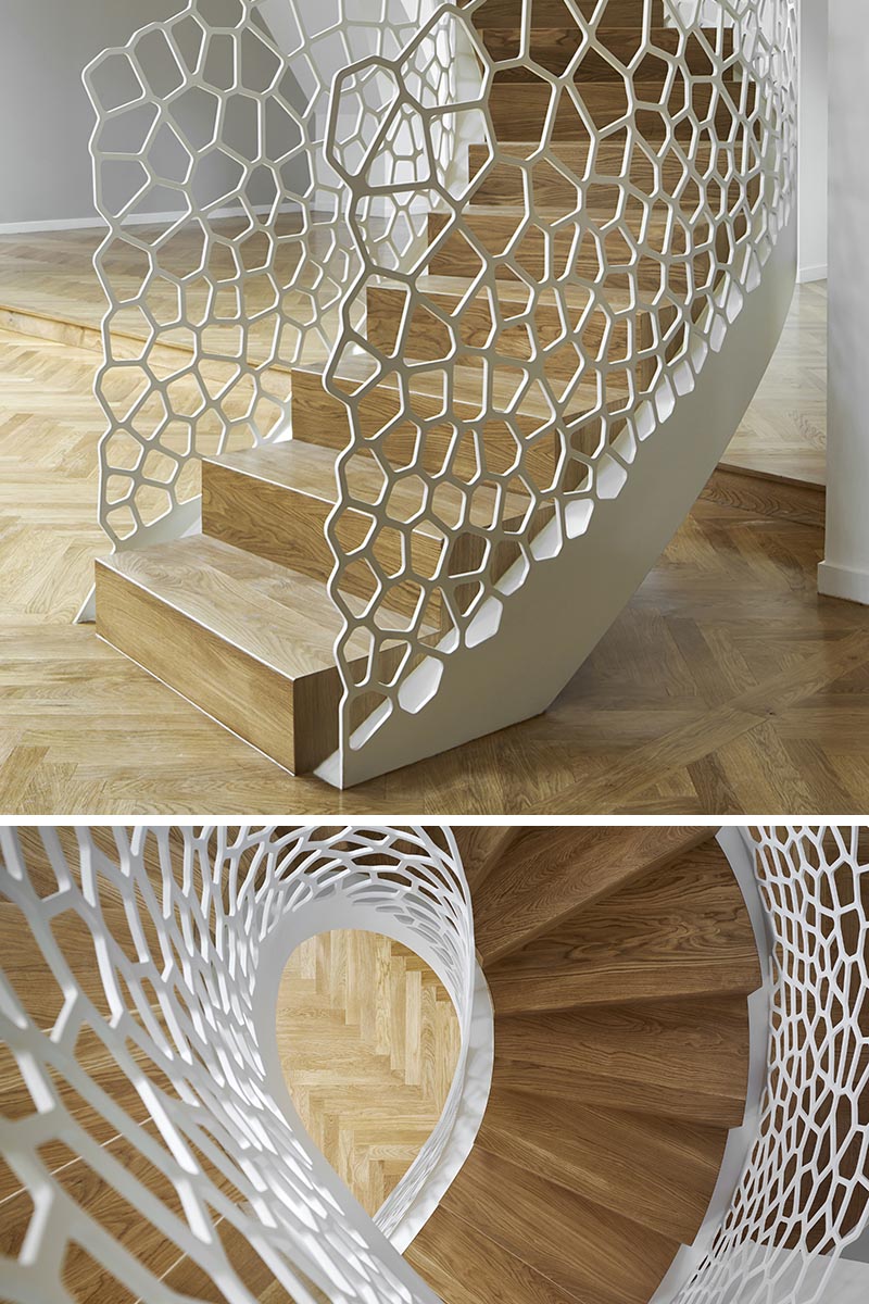 This Parisian apartment features an artistic white spiral staircase with organic cell-like shapes for the balustrade. #SpiralStaircase #WhiteSpiralStairs #WhiteStaircase #SculpturalStairs #ArtisticStairs