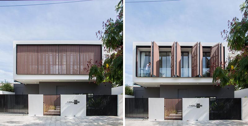 Wood shutters cover the second floor of this modern house.