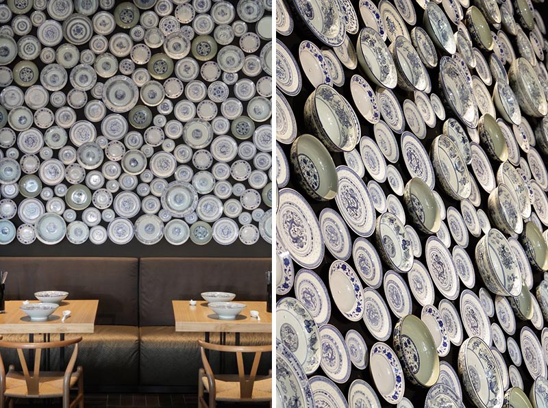 A modern restaurant with an accent wall made from traditional noodle bowls and plates.