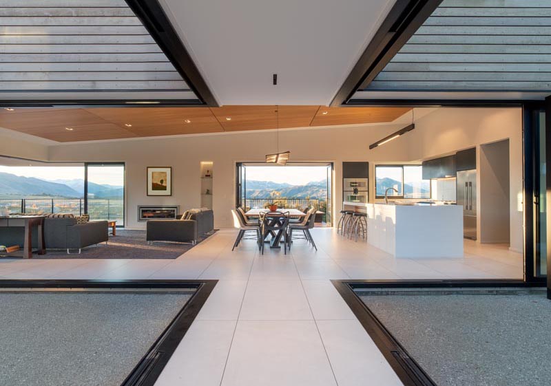 Retractable glass walls connect this New Zealand house with the outdoors.