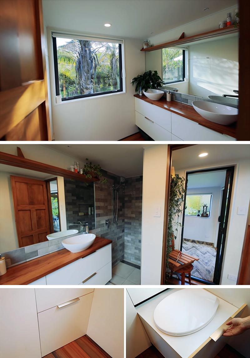 A tiny house bathroom with double vanity, a full shower, and a pull-out composing toilet.