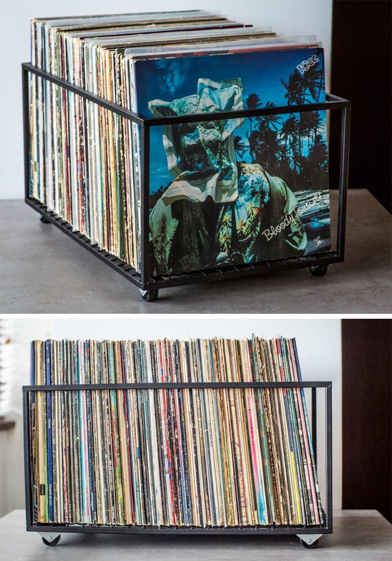 A minimalist black metal cube with wheels for storing vinyl records.