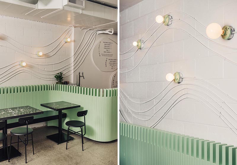 Electrical conduit was used to create wave-like wall art in this restaurant design.