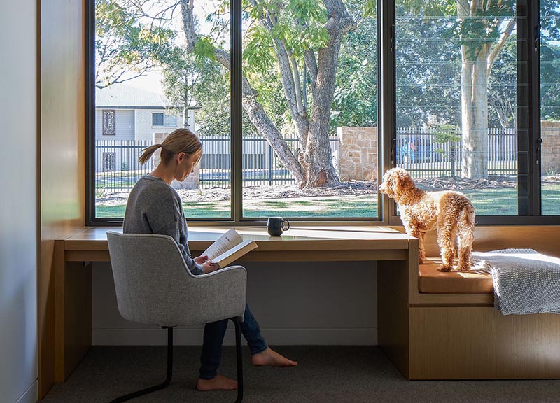 A Built-In Bench And Desk Complete The Window In This Bedroom