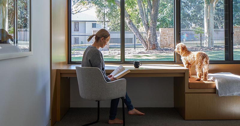 A Built-In Bench And Desk Complete The Window In This Bedroom