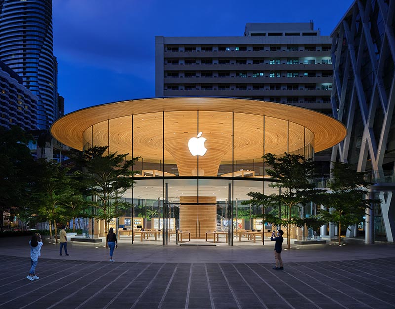 Apple Central World features a eye-catching cylindrical glass facade with views of a large sculptural wood core.