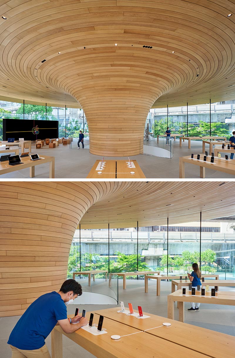 Apple Central World includes an eye-catching cylindrical glass facade with views of a large sculptural wood core.