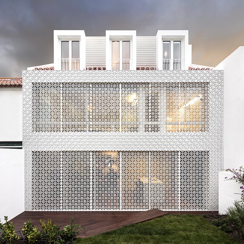 White patterned screens add a decorative element to this house, as well act as a sunlight filter and a security screen