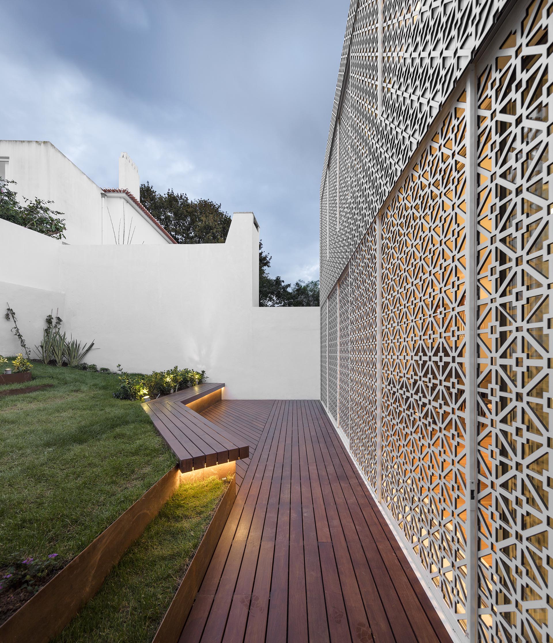 Sliding screens with a decorative pattern open this house to the backyard.