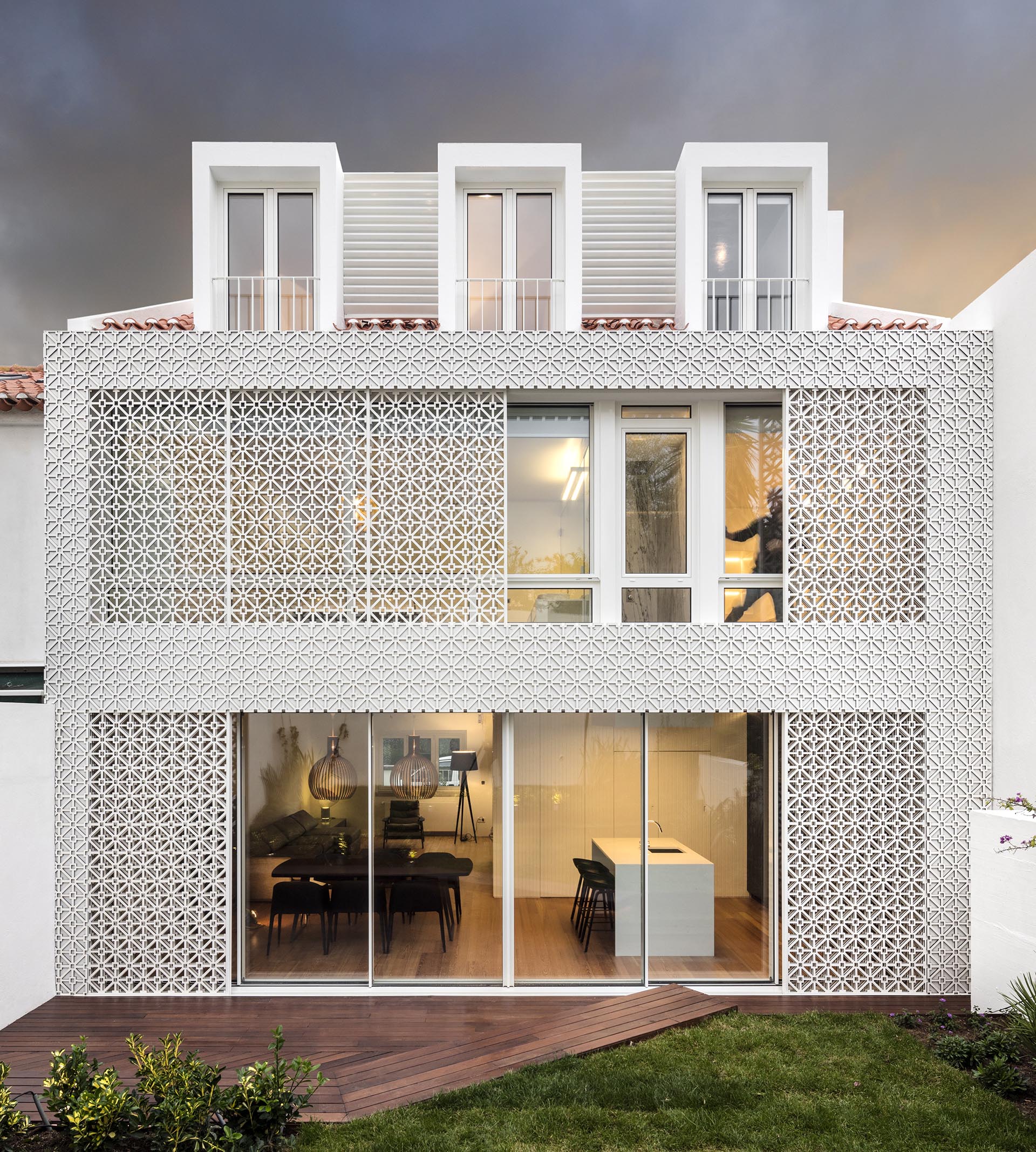 Sliding patterned screens provide shade, security, and a decorative element to this house.