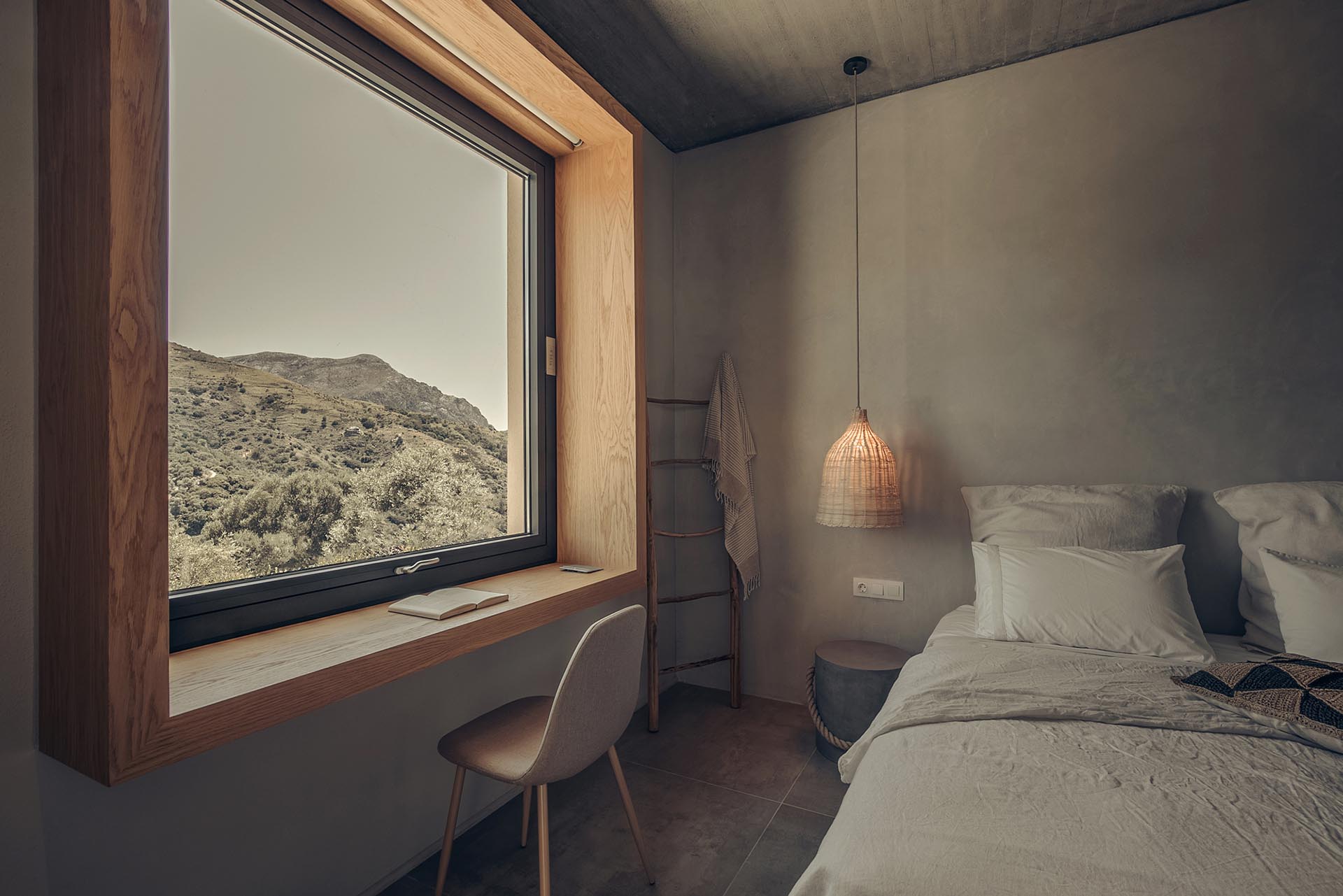 A deep wood window frame that doubles as a desk.