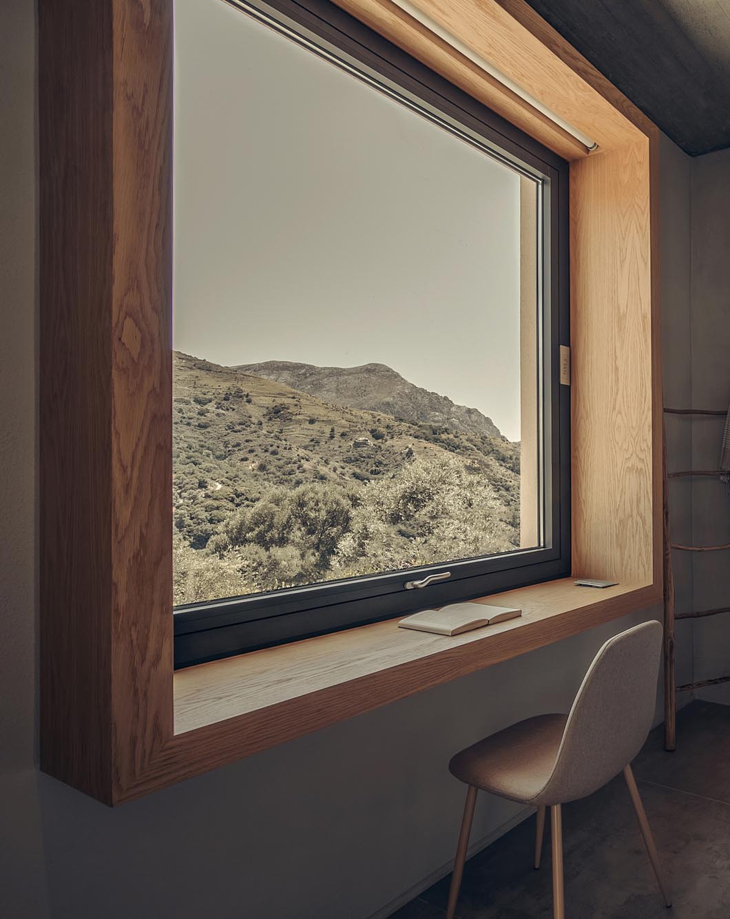 A deep wood window frame that can be used as a desk.