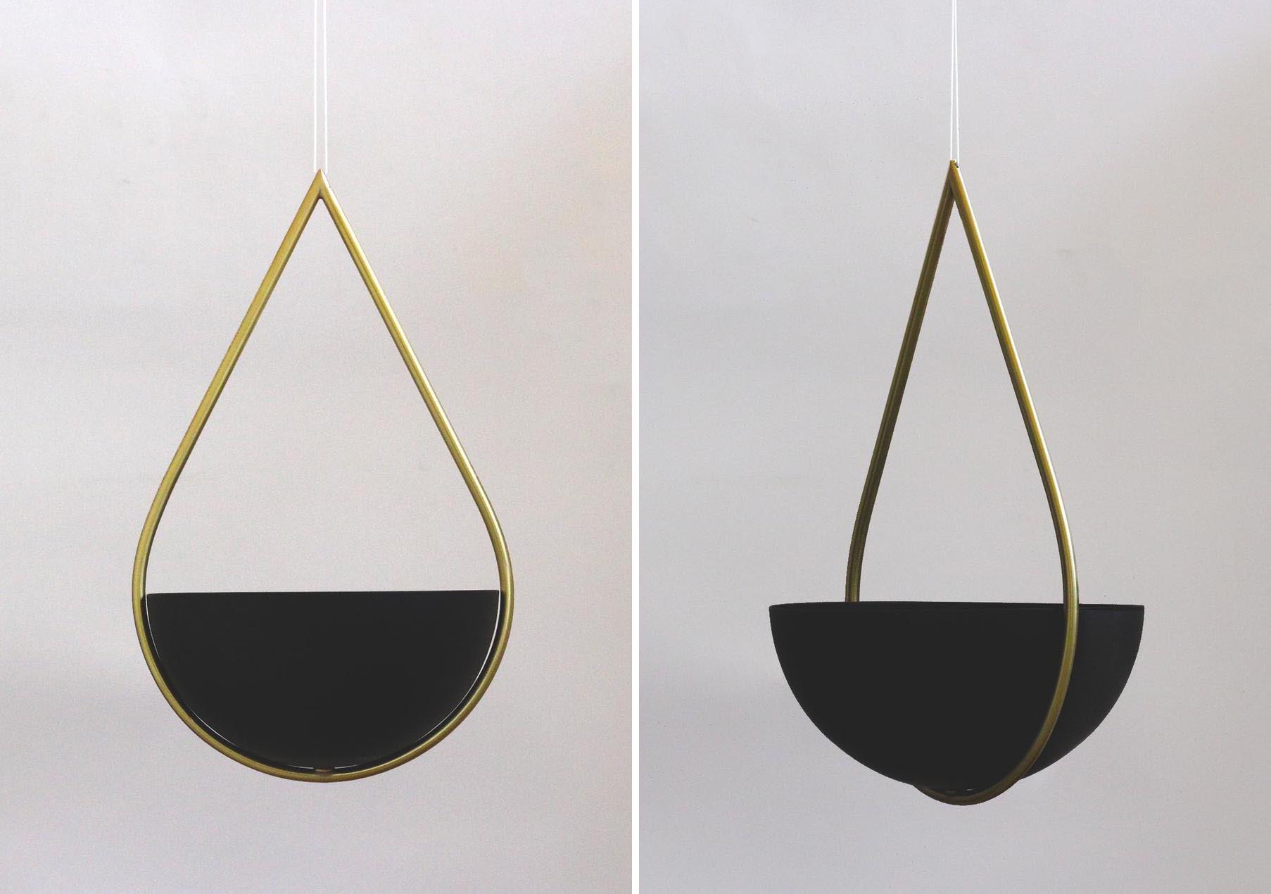 A hanging planter with a brass and matte black finish.