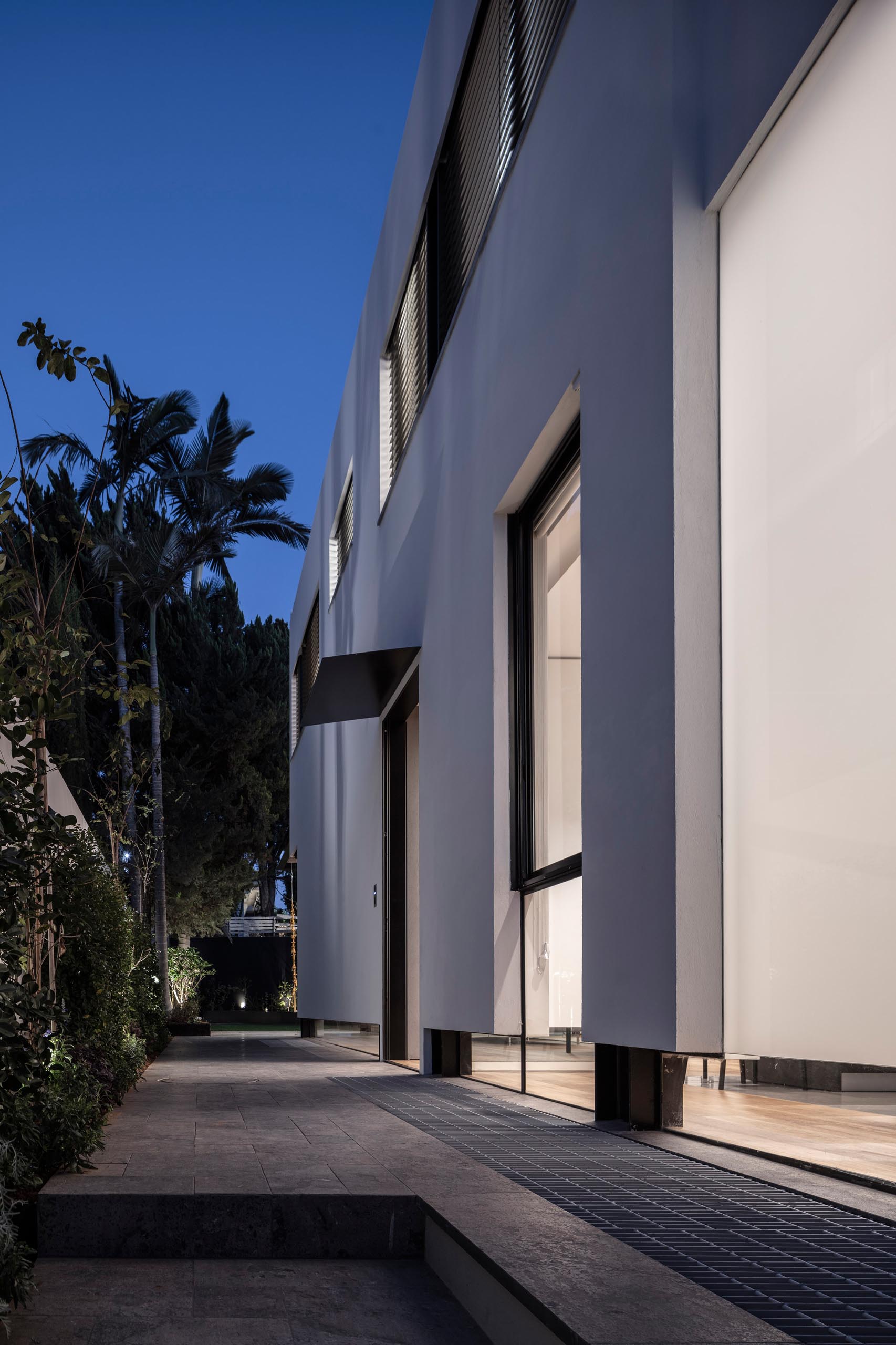 A low window runs the length of the the front wall of this house.