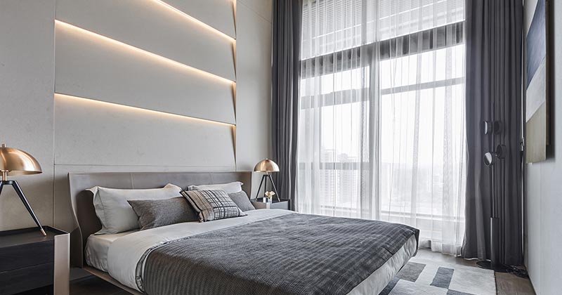 A Layered Accent Wall With Indirect Lighting Creates A Glow Above The Headboard In This Bedroom