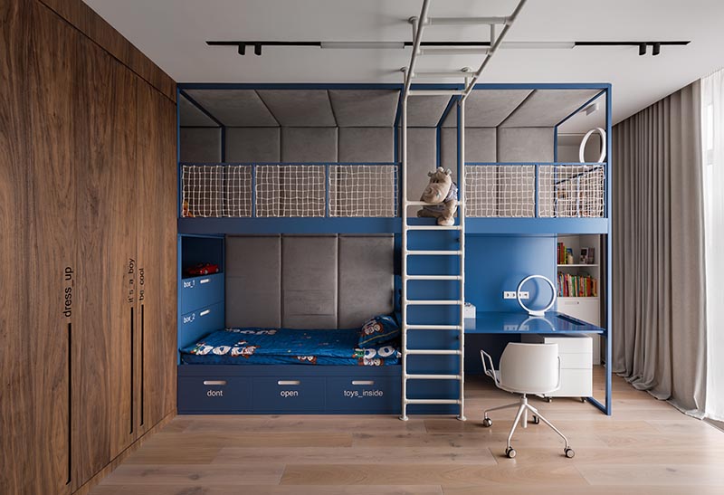 A modern kids bedroom with a custom-designed bed that includes a lofted play space and a homework station.