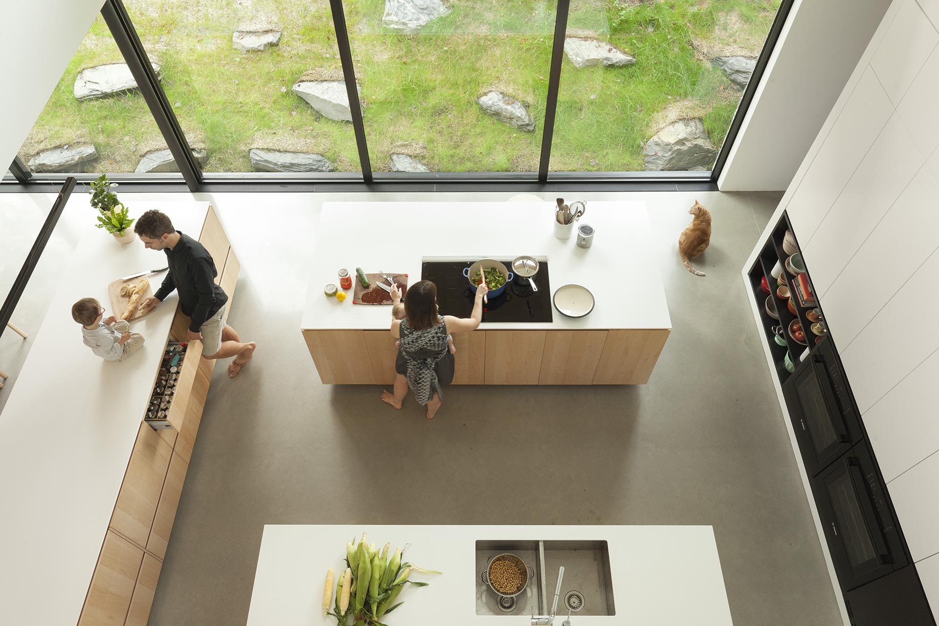 A modern kitchen with three kitchen islands that each have different functions.