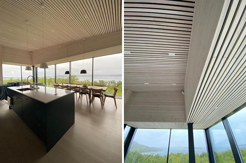 A modern house interior with wood slat ceiling.