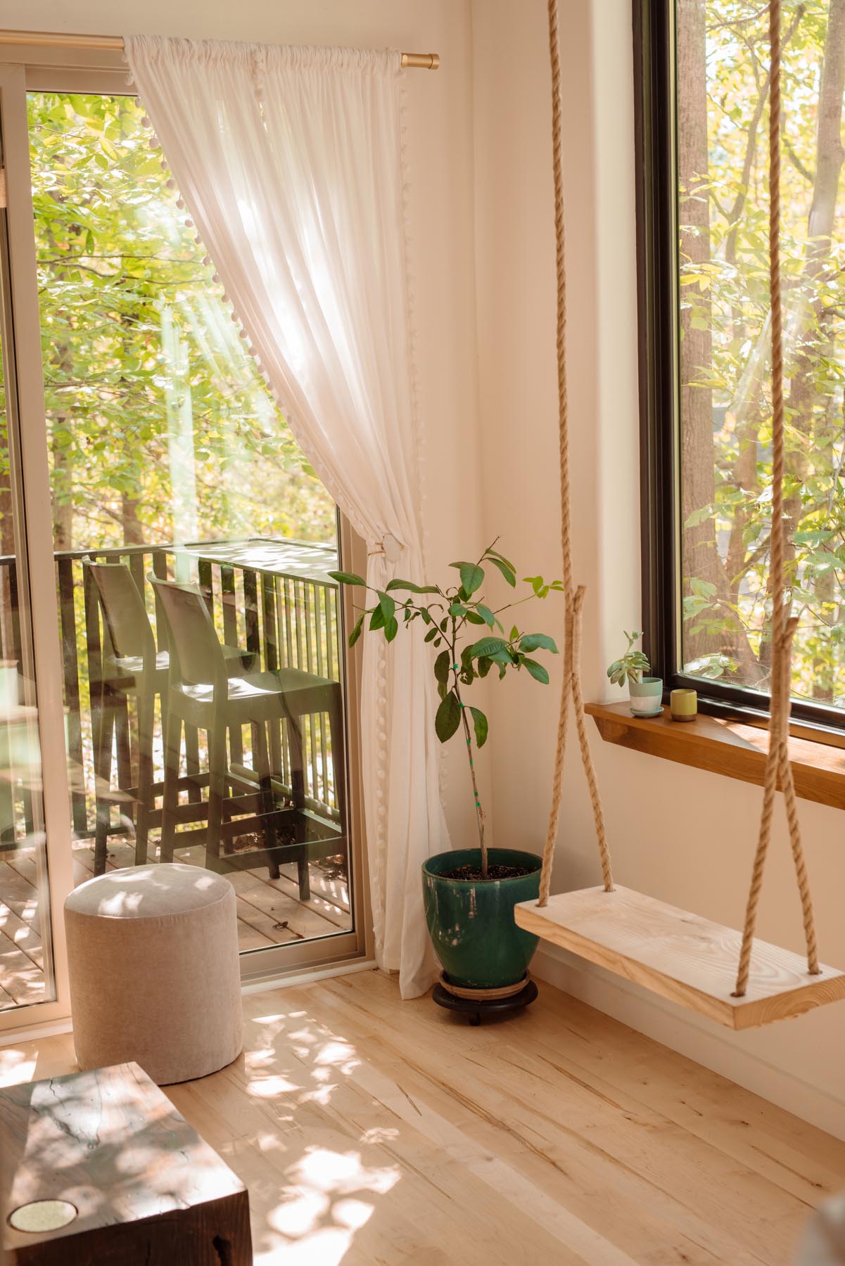 A swing beside a window inside a small house