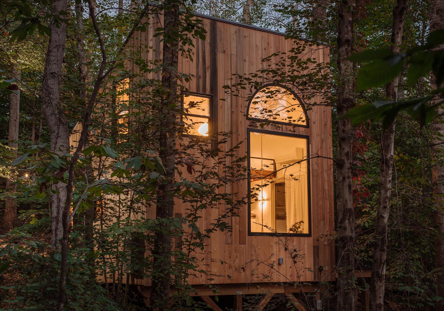 A small wood house with an arched window.