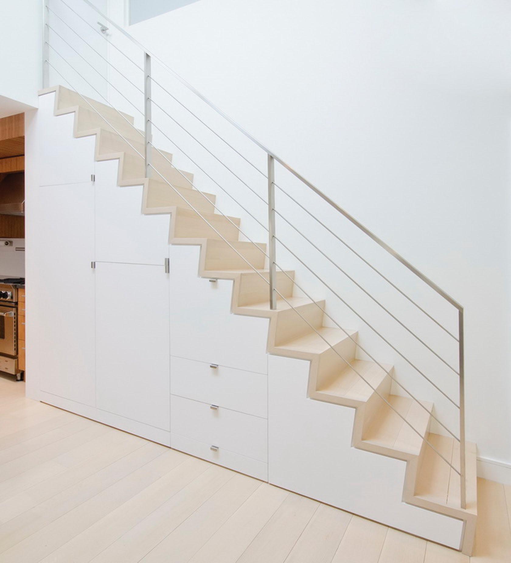 Under stair storage made from white cabinetry.