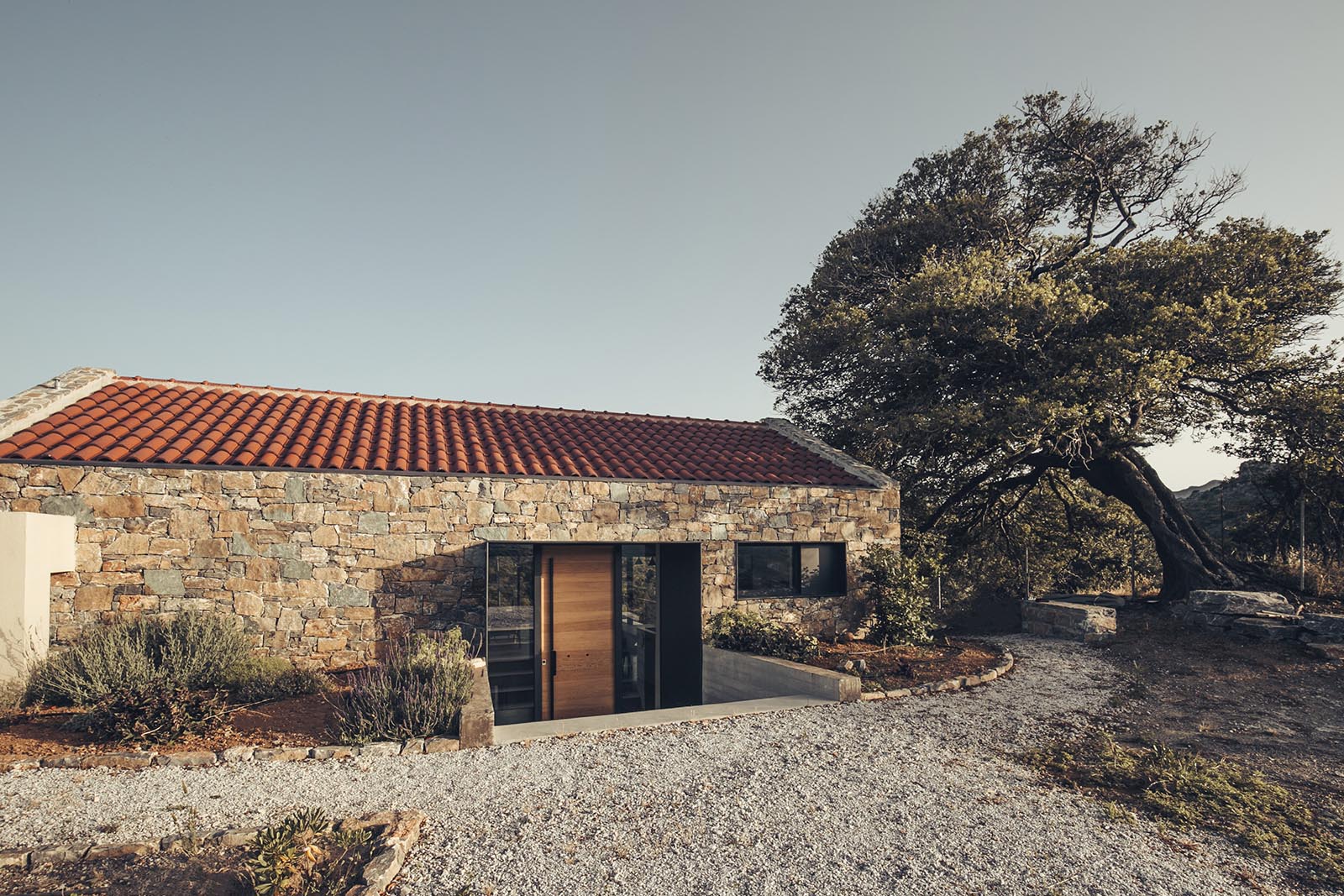 A stone house with black metal accents.