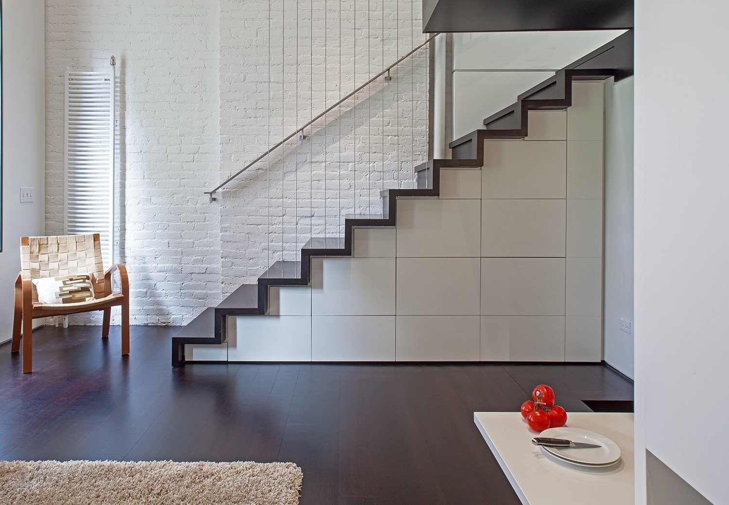 Stairs with built-in storage in the form of cabinets and drawers.