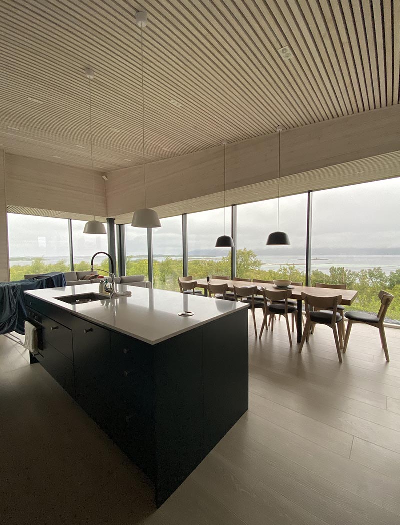 Wood slat ceilings, wood floors, and large windows give this cabin a cozy atmosphere.