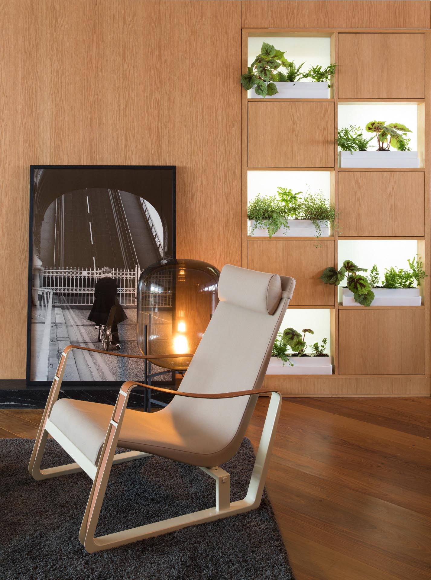 White indoor planters are highlighted by hidden lighting.