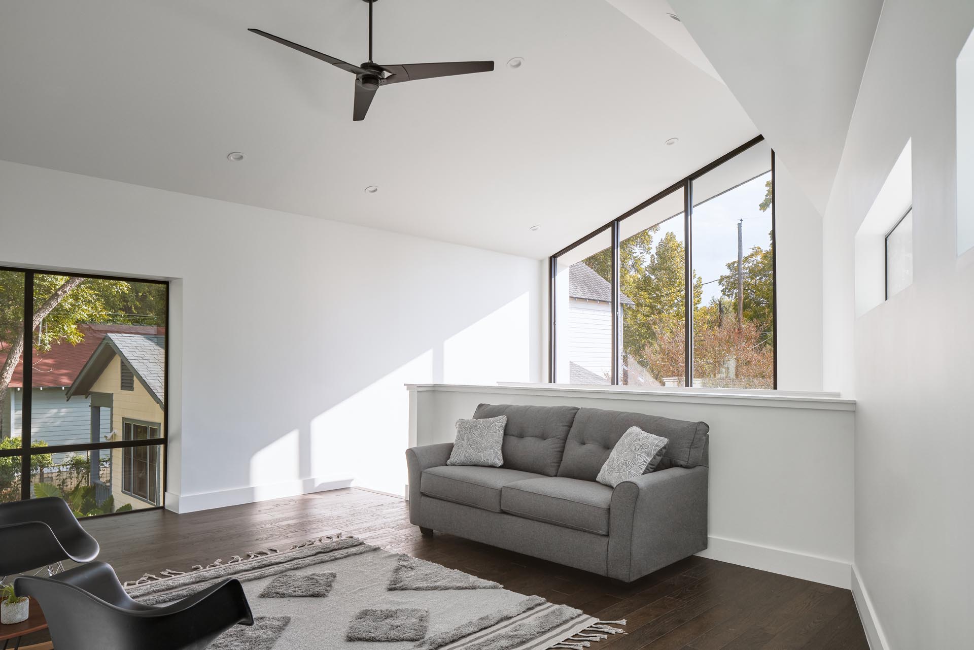 A small sitting area with a sofa at the top of the stairs.