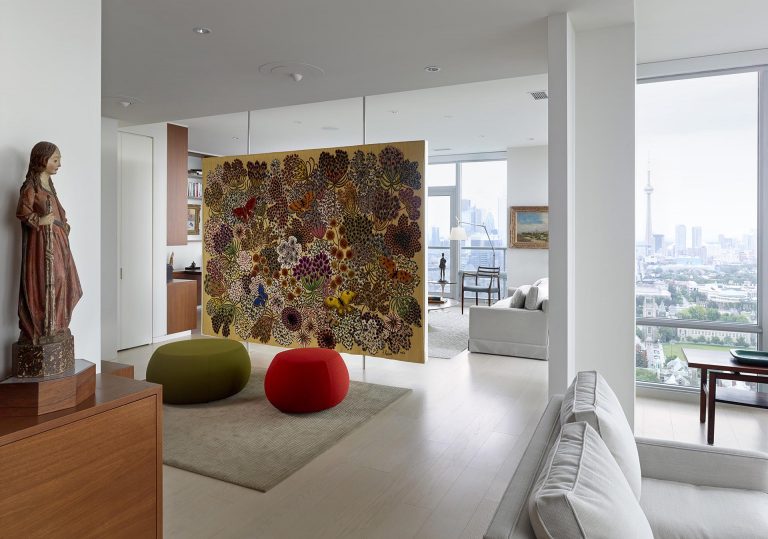 A Floating Room Divider Is Used To Display Artwork In This Apartment