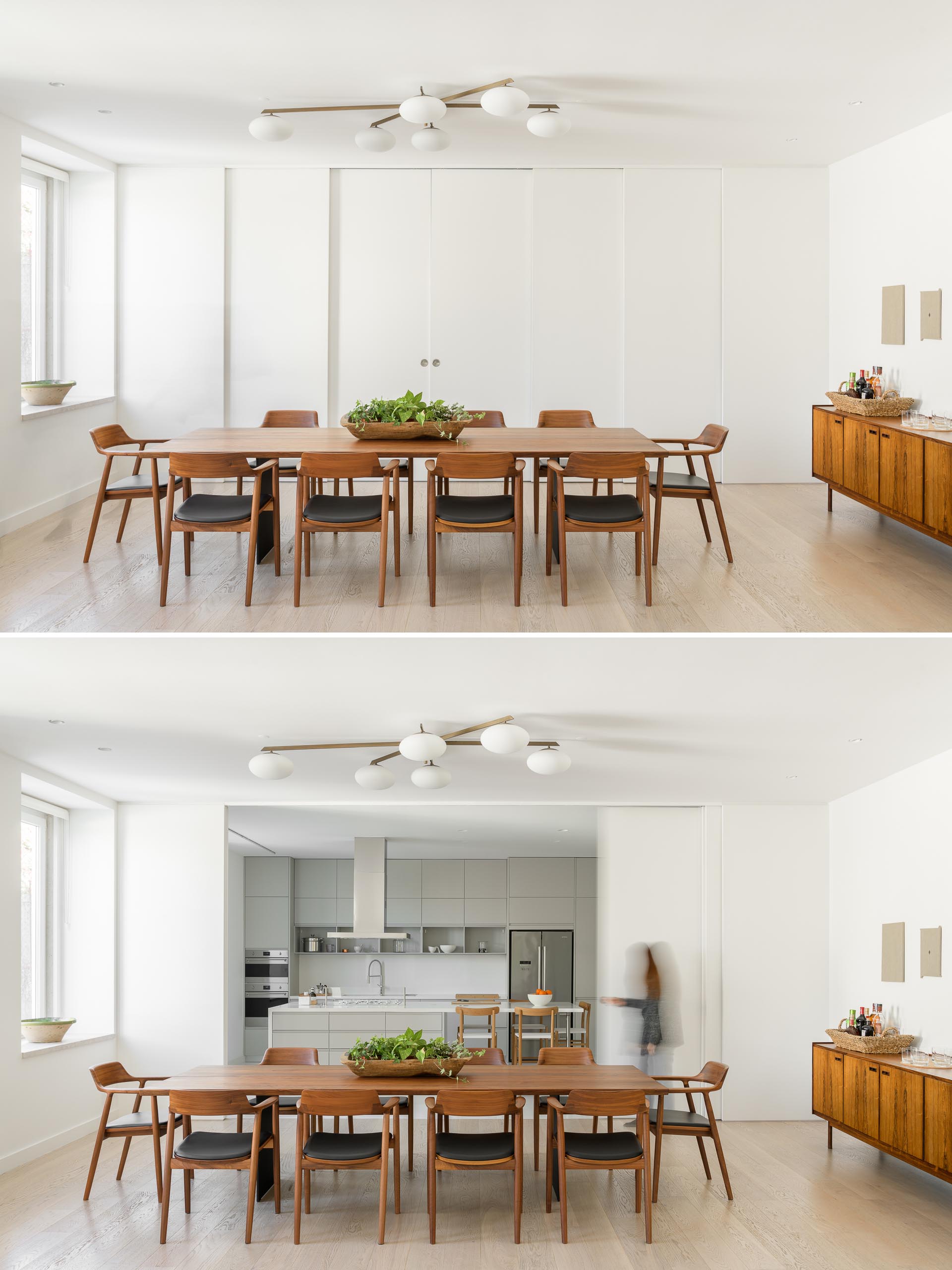 Sliding white panels doors hide the kitchen from the dining room.