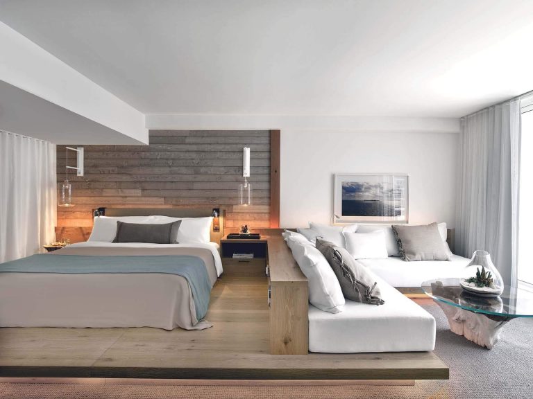 Get Bedroom Design Ideas From This Hotel Room With A Wood Platform And Built-In Sofa