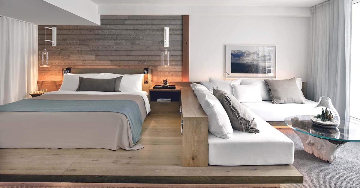 Get Bedroom Design Ideas From This Hotel Room With A Wood Platform And Built-In Sofa