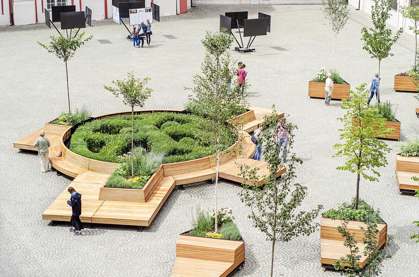 Mobile benches wrap around a circular garden.