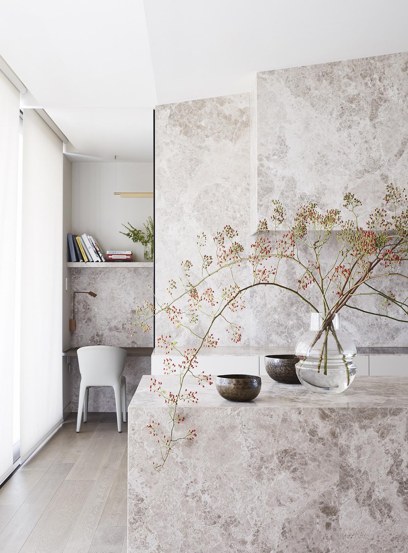 Stone used in the kitchen carries through to a small desk area.