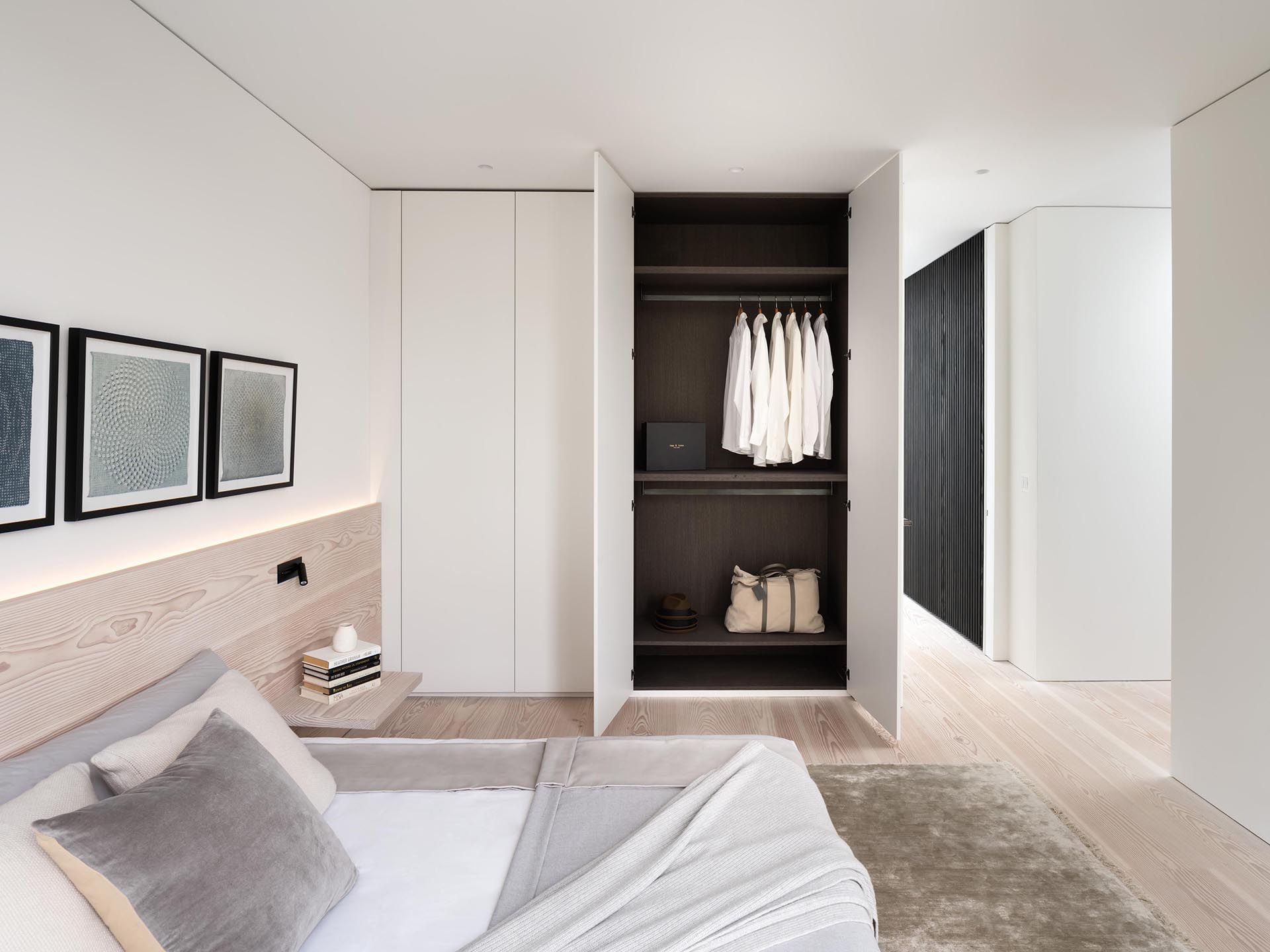 Bedroom with lighting wood headboard and hidden lighting.