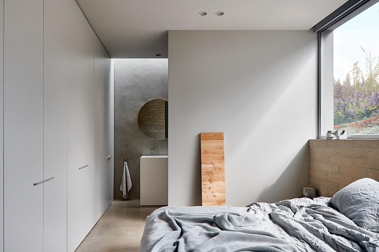 Minimalist bedroom with ensuite bathroom.