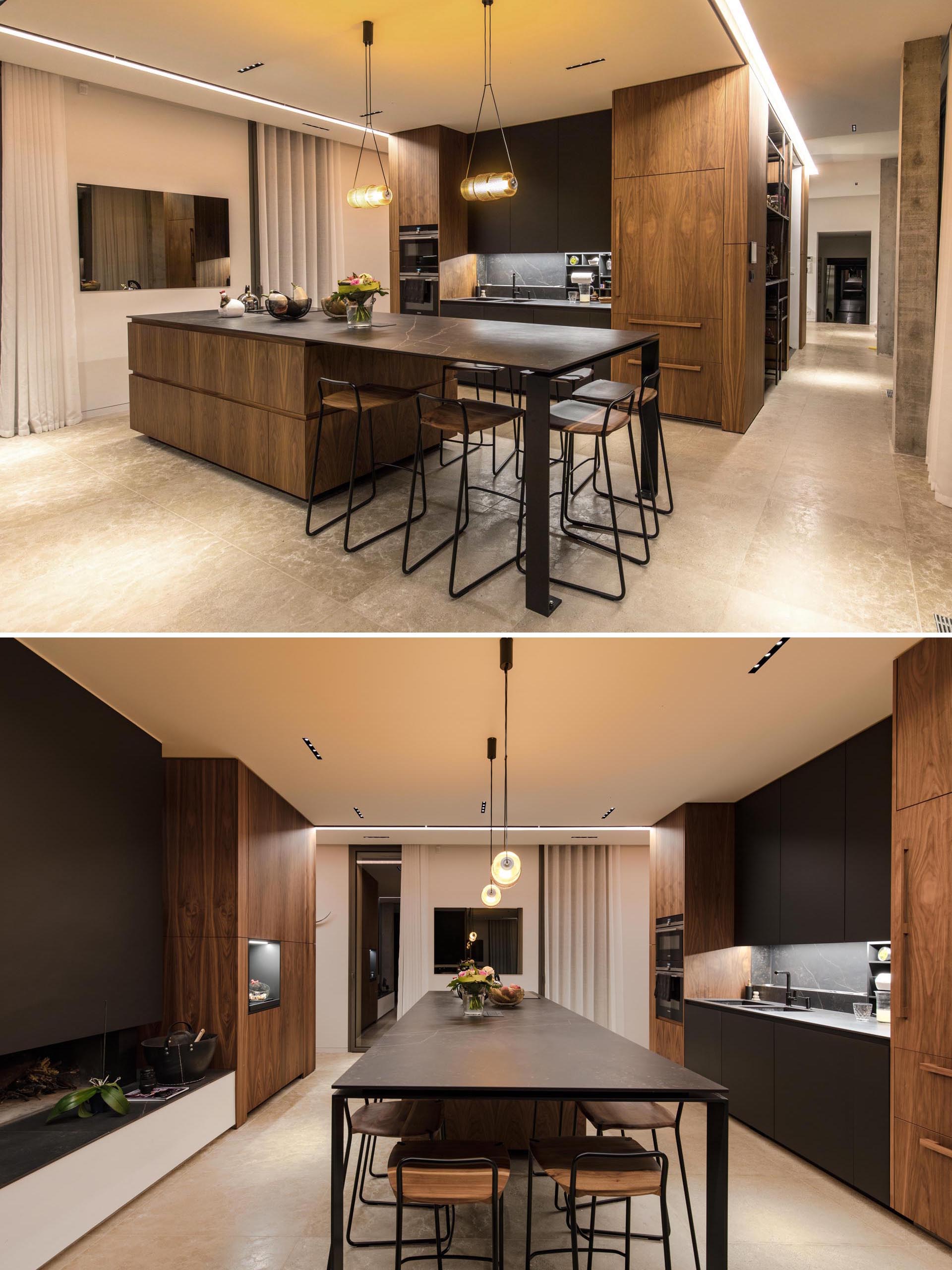 A black and wood kitchen with an island.