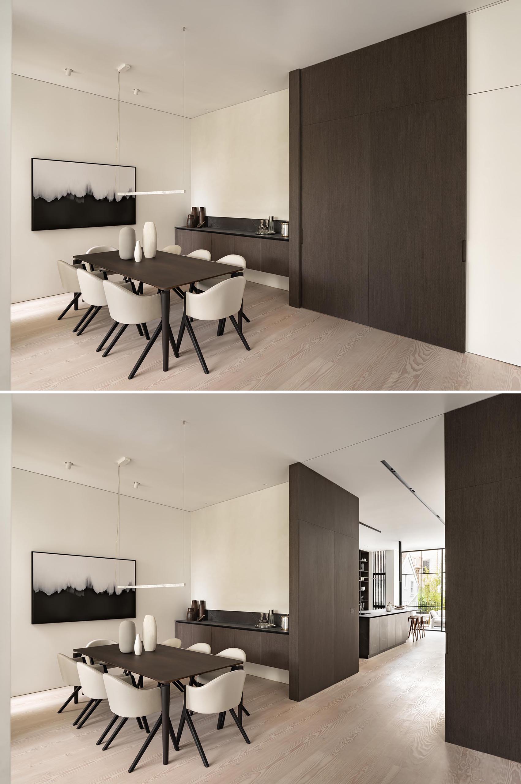 A modern dining room with a large sliding wood door.