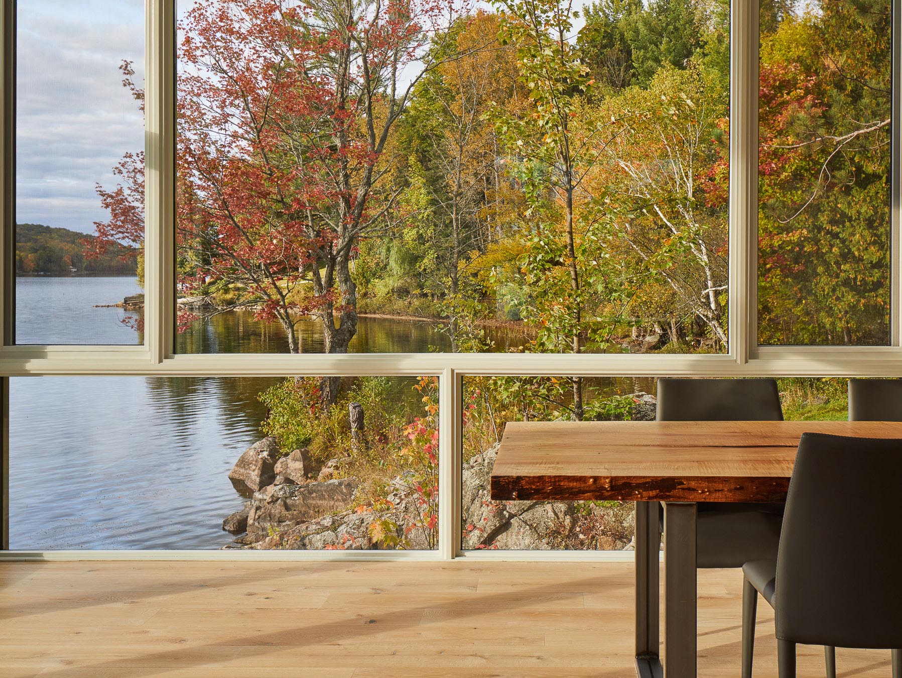 A dining room with framed windows and water views.