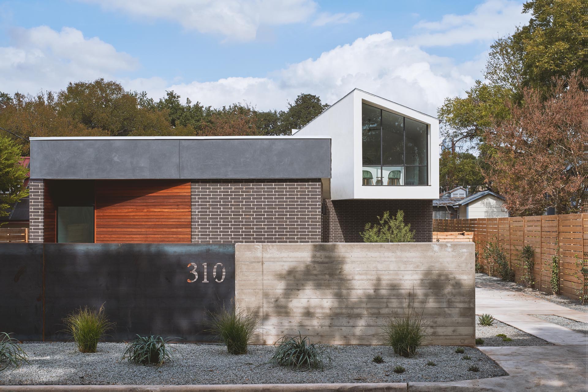 A modern house with an angled upper floor.