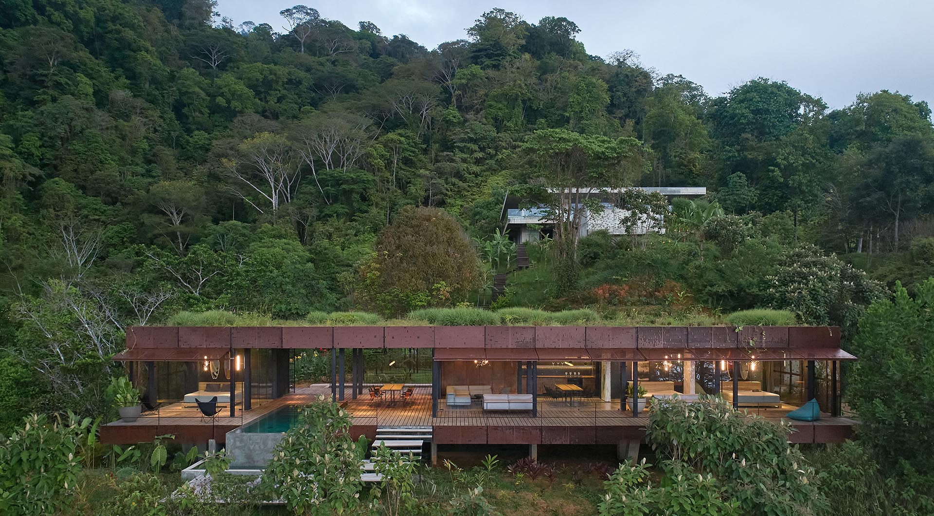 A modern house with a green roof.