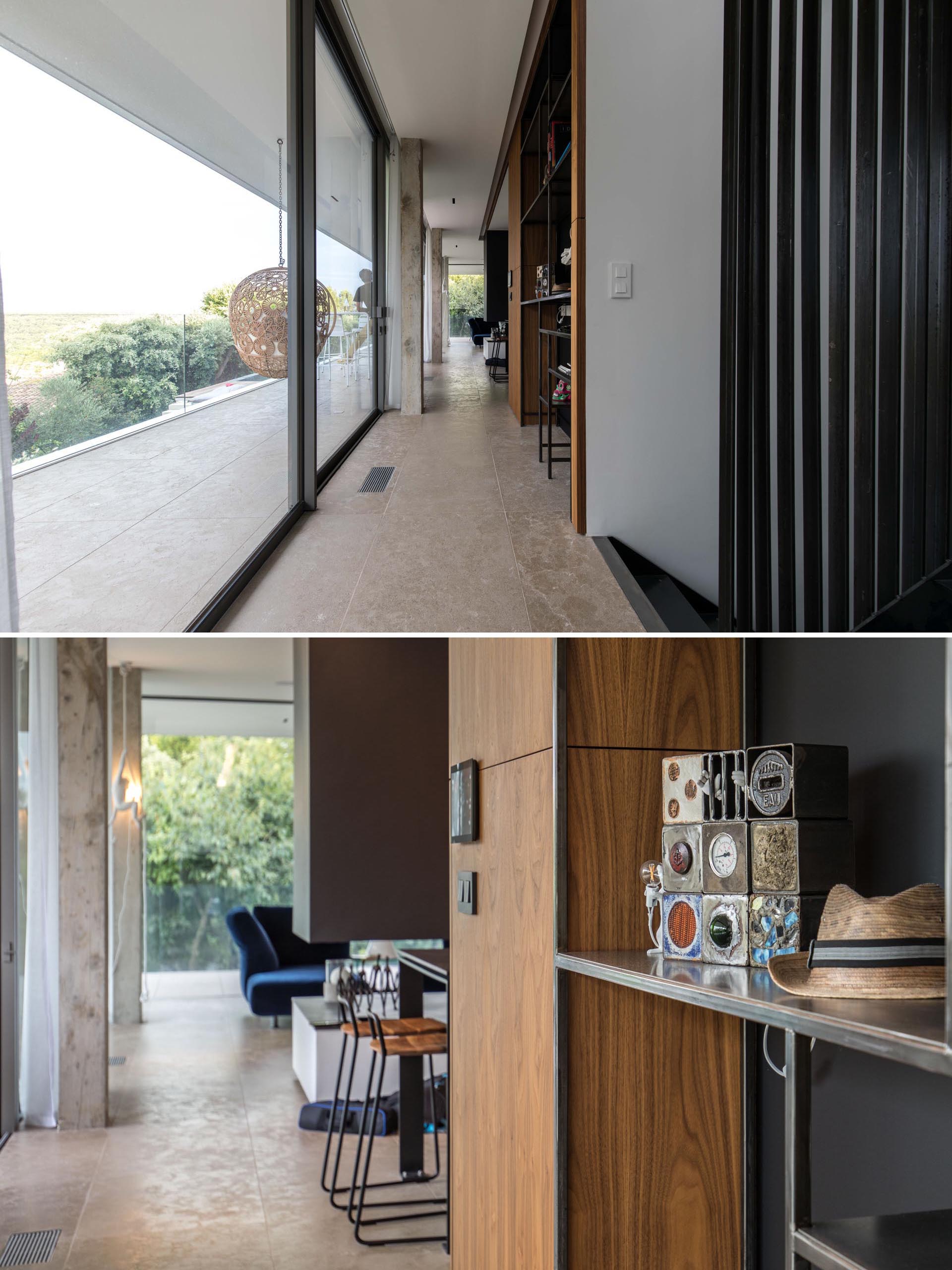 A modern house with glass walls and a long hallway.