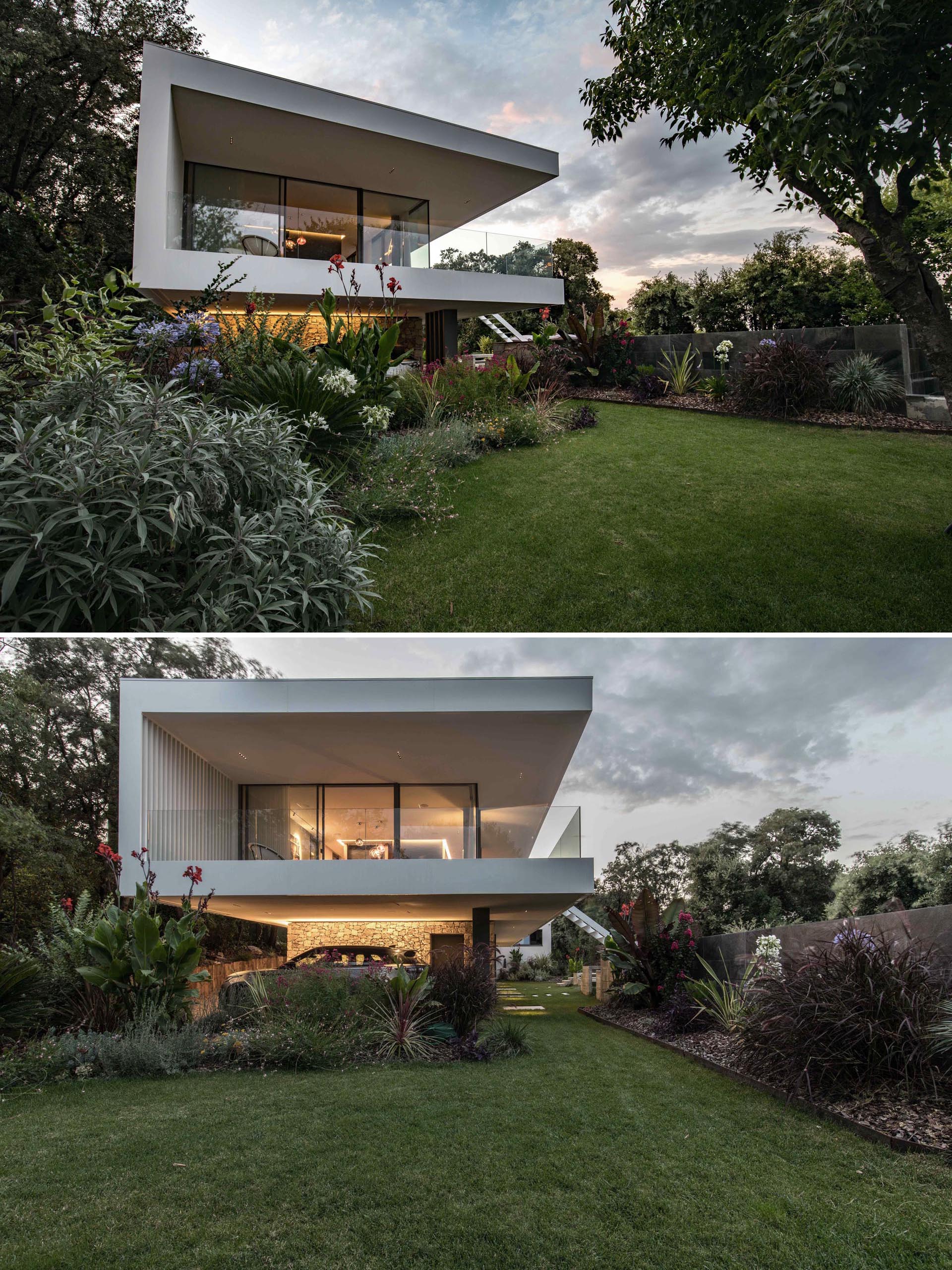 A white modern house extension with a wrap around balcony.