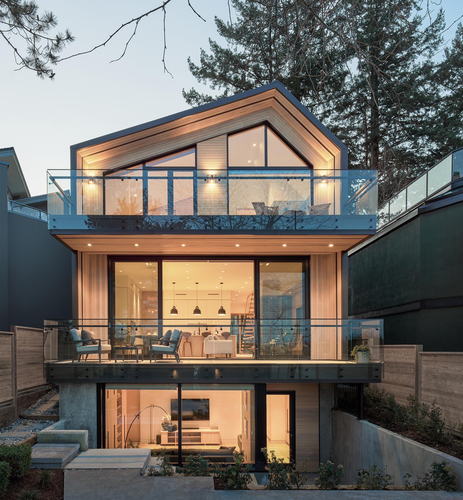 Cedar, black metal, and glass are used to create a contemporary house design.