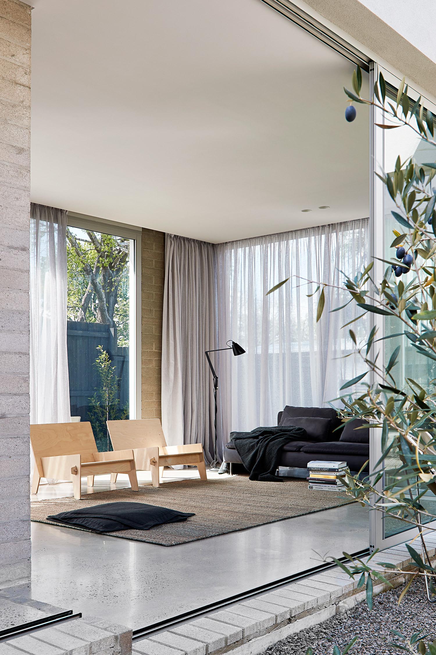 Modern living room with wood armchairs.