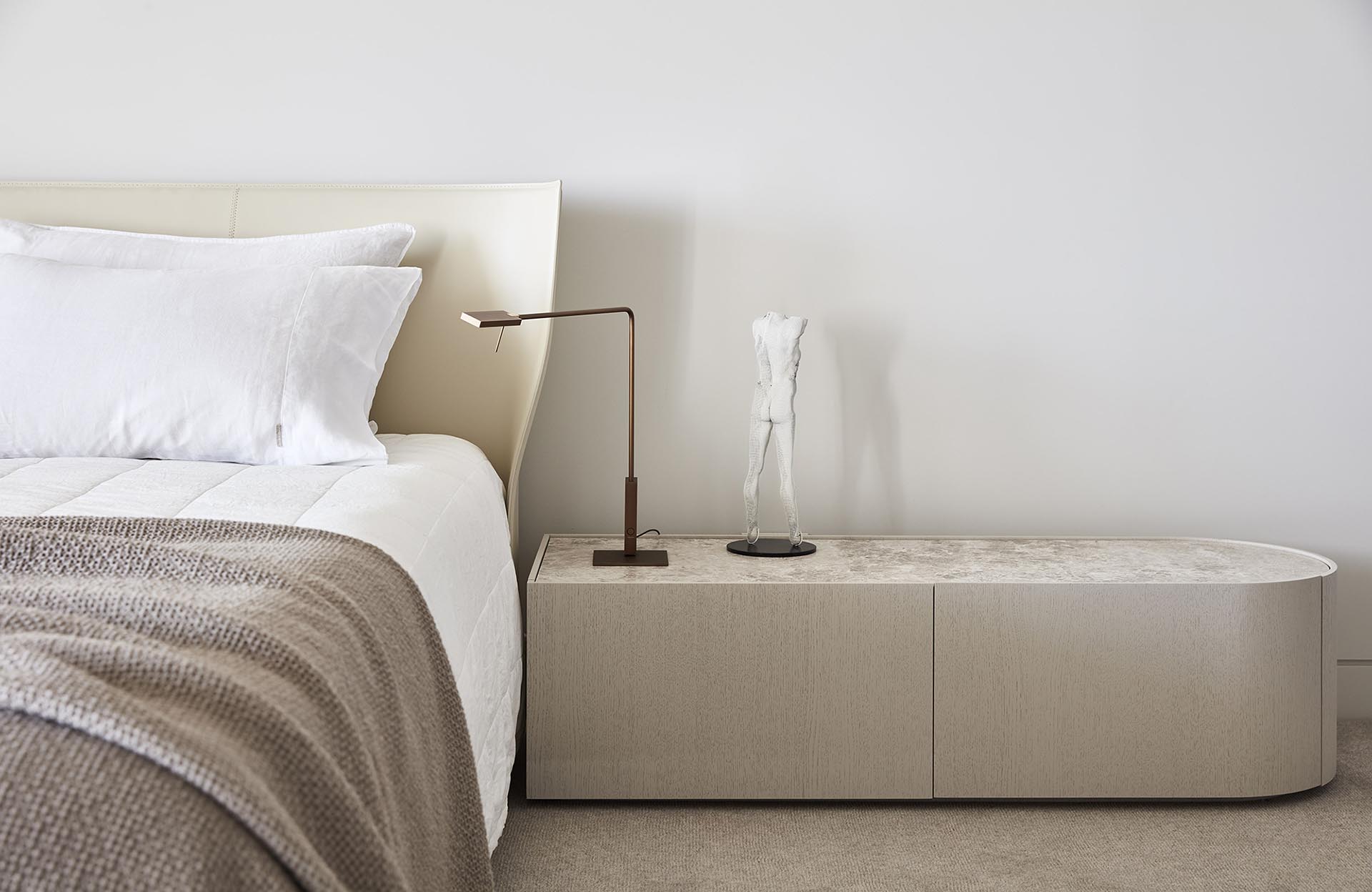 A modern bedroom with a neutral color palette.