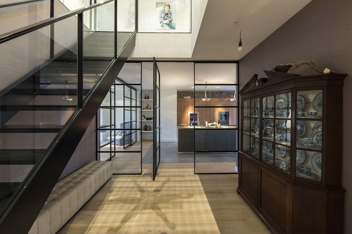 Black Framed Glass Doors Are A Prominent Feature Of This Apartment's ...