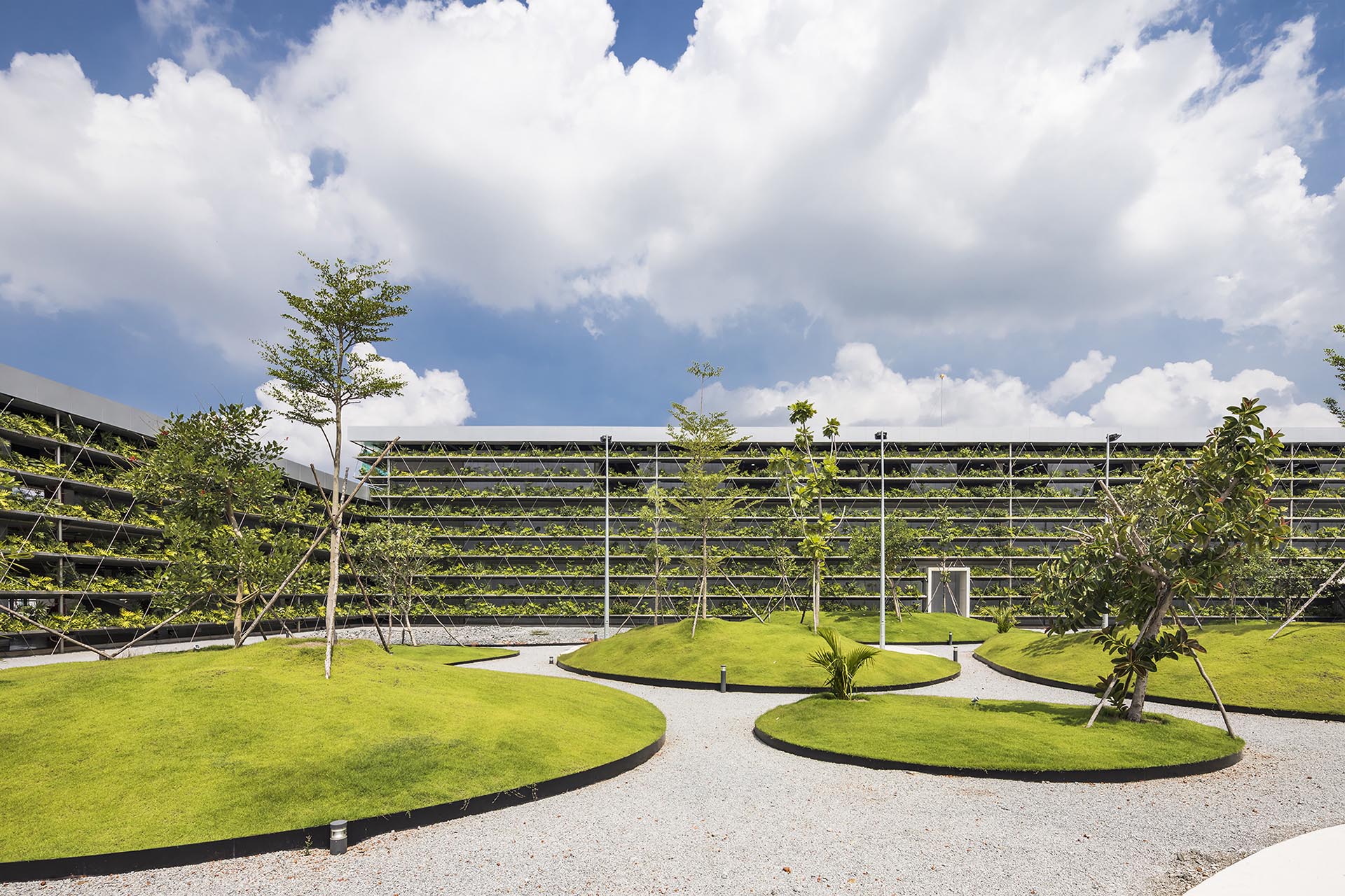 A central courtyard with grassy patches and trees.